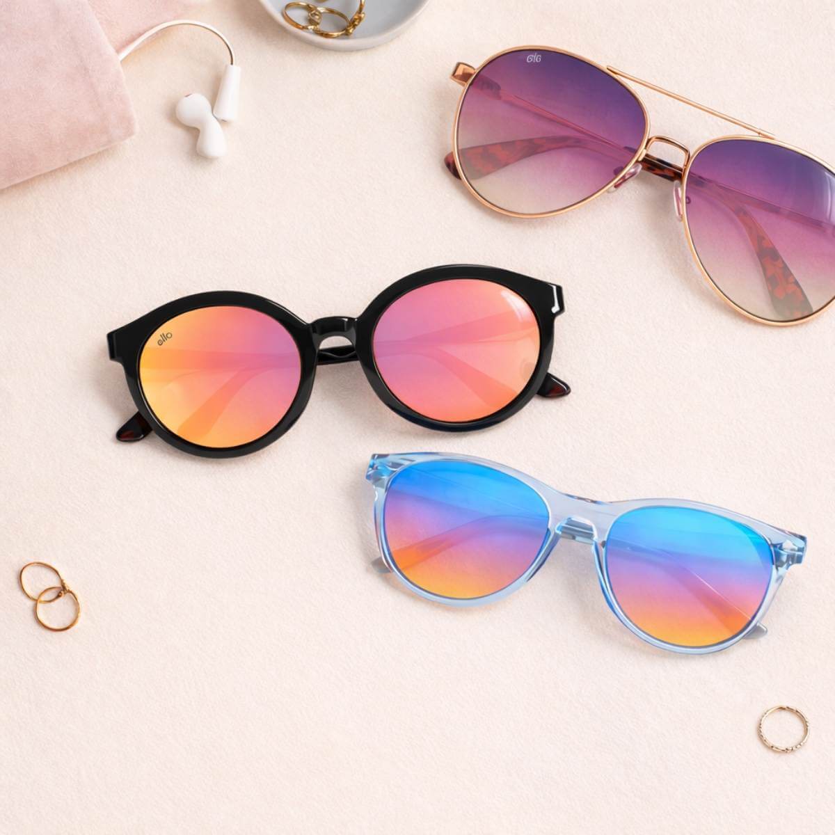 Flat lay showing three petite sunglasses frames designed for small faces highlighting frame proportion and fit balance on a soft neutral background