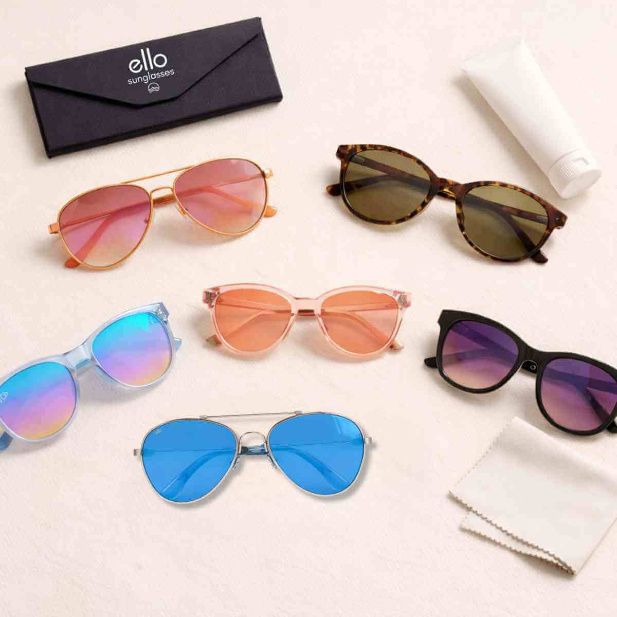 Flat lay editorial image of petite sunglasses frames designed for small faces showing multiple frame styles arranged with accessories on a clean neutral background