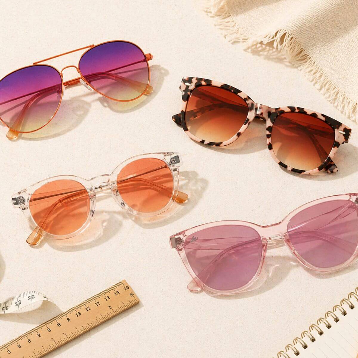 small head sunglasses arranged in flat lay with petite frames and measuring tools designed for small heads and narrow faces