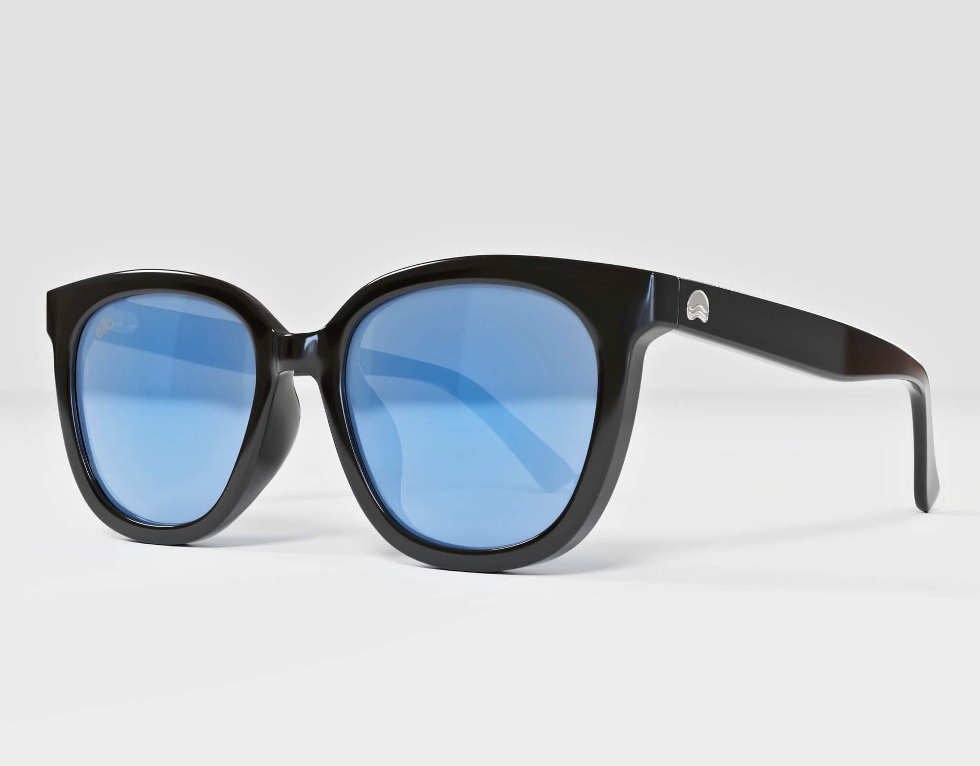 Side view of Pebble Beach sunglasses in black with cool blue lenses, styled for smaller face types.