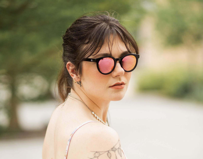 Black pink Bar Harbor small sunglasses for small faces shown on a woman in soft natural light