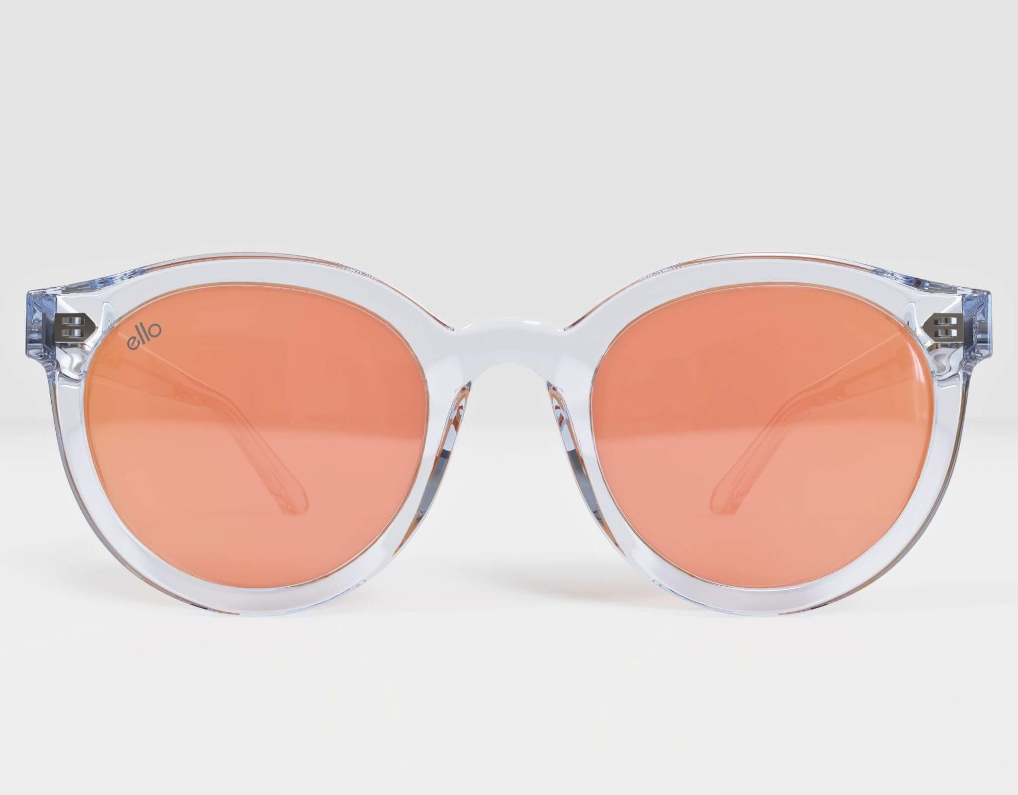Front view of Bar Harbor sunglasses in a clear frame with polarized peach lenses, sized for petite heads.