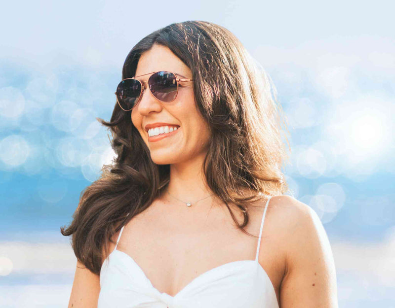 Gold Bali aviator small face sunglasses with lavender tinted polarized lenses shown in close-up detail