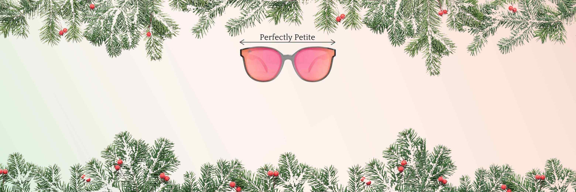 Holiday garland framing petite-fit pink lens sunglasses for small heads on a soft pastel background.