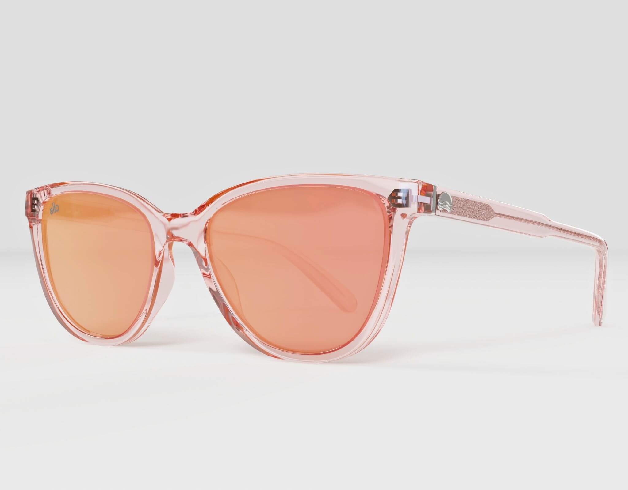 Side view of Half Moon Bay cat eye sunglasses in soft pink frame with peach lenses, ideal for smaller faces.