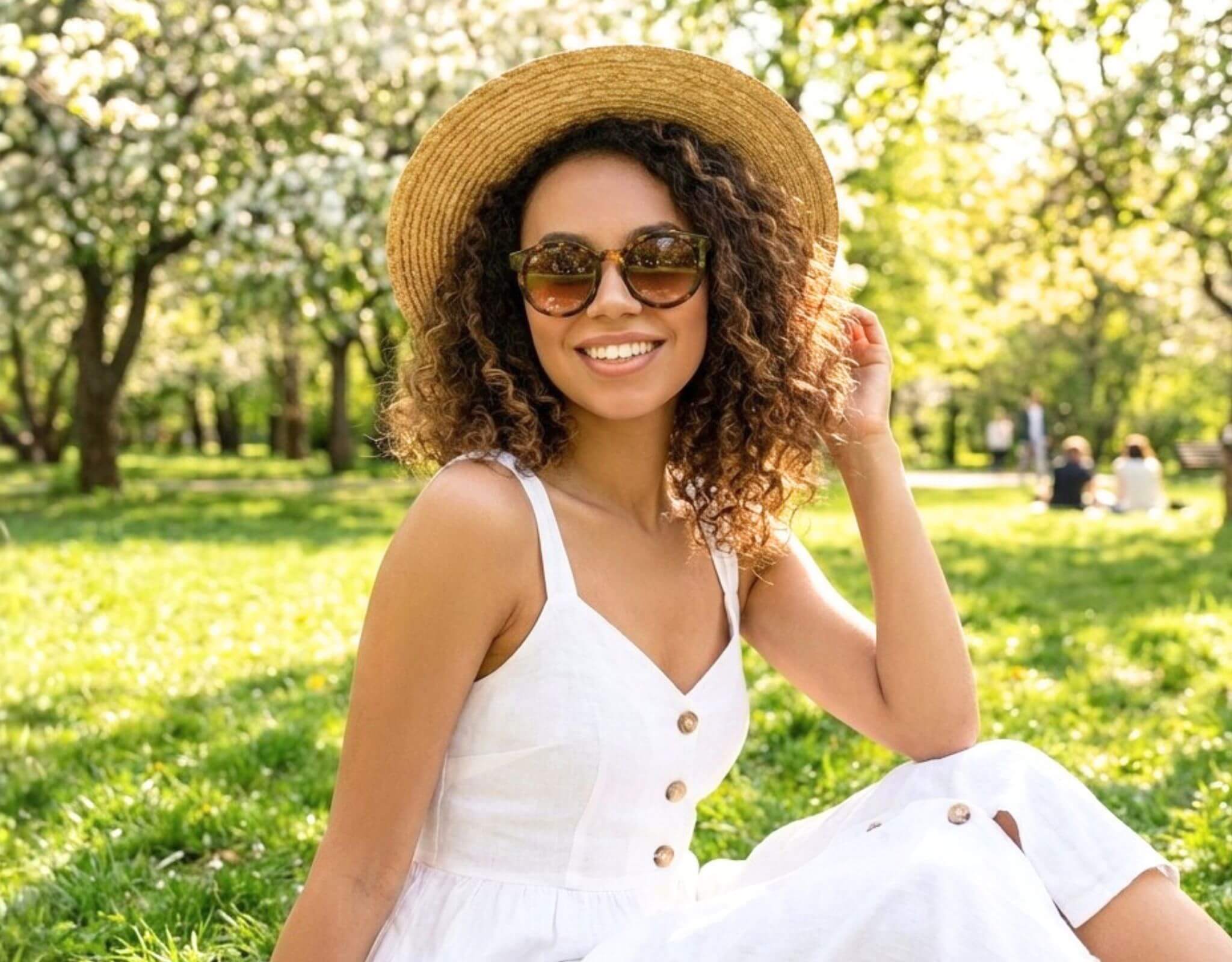 Small sunglasses for small faces worn by woman in Bar Harbor tortoise frame with amber lenses in sunny park, flattering petite features and small head by ello sunglasses