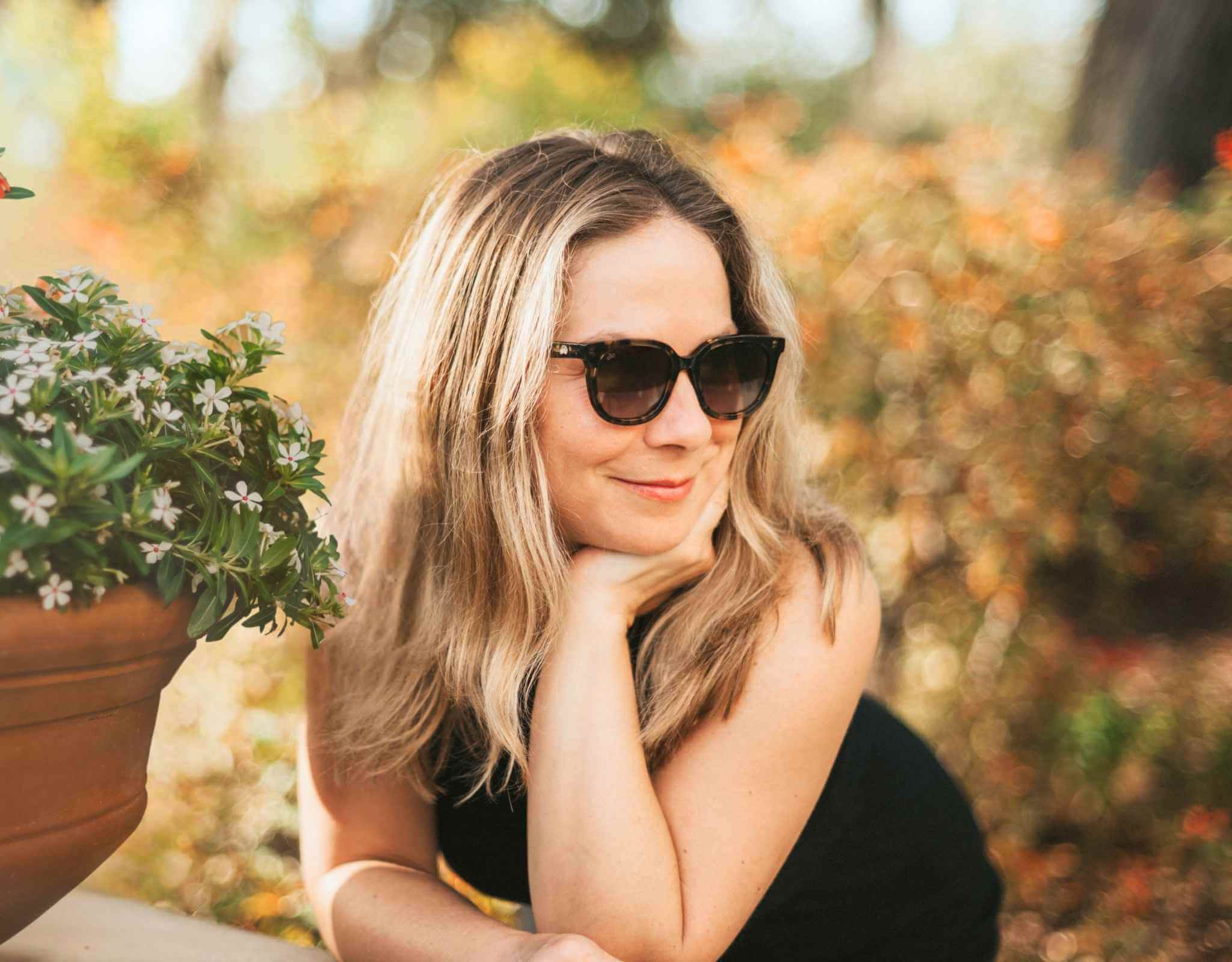 Stylish woman in tortoise amber Pebble Beach sunglasses for little faces with windswept hair and a confident look.